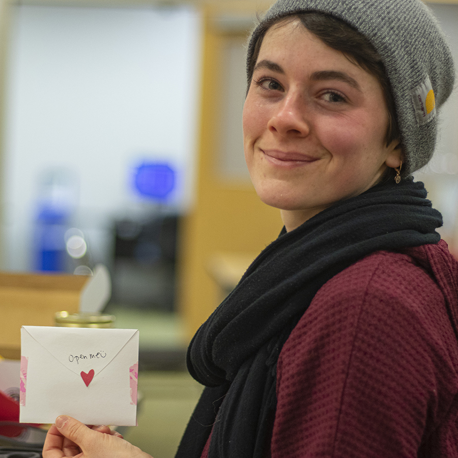 A student holds a note card