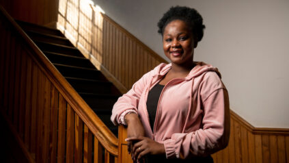 Picture of Aminata standing by the staircase