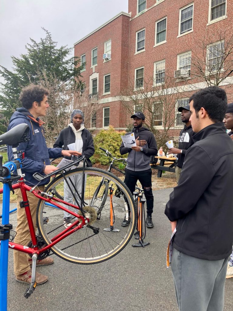 IEI students stand next to bicycles opposite Erik