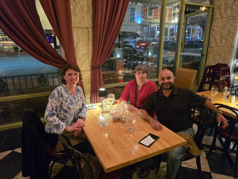 Orlina, Anuket, and Carleena sitting at a restaurant table.