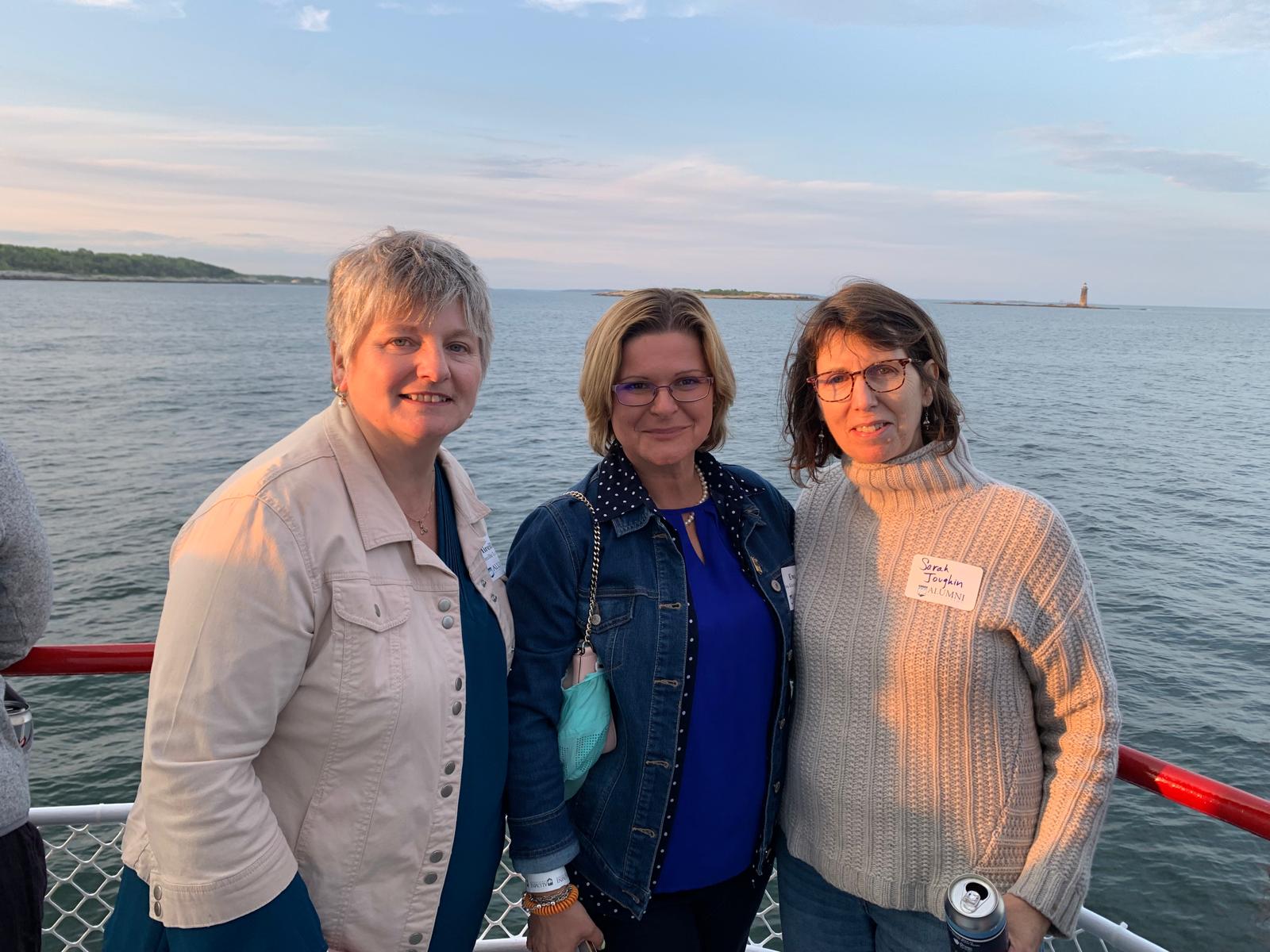 Mireille, guest, and Sarah in group photo on a boat