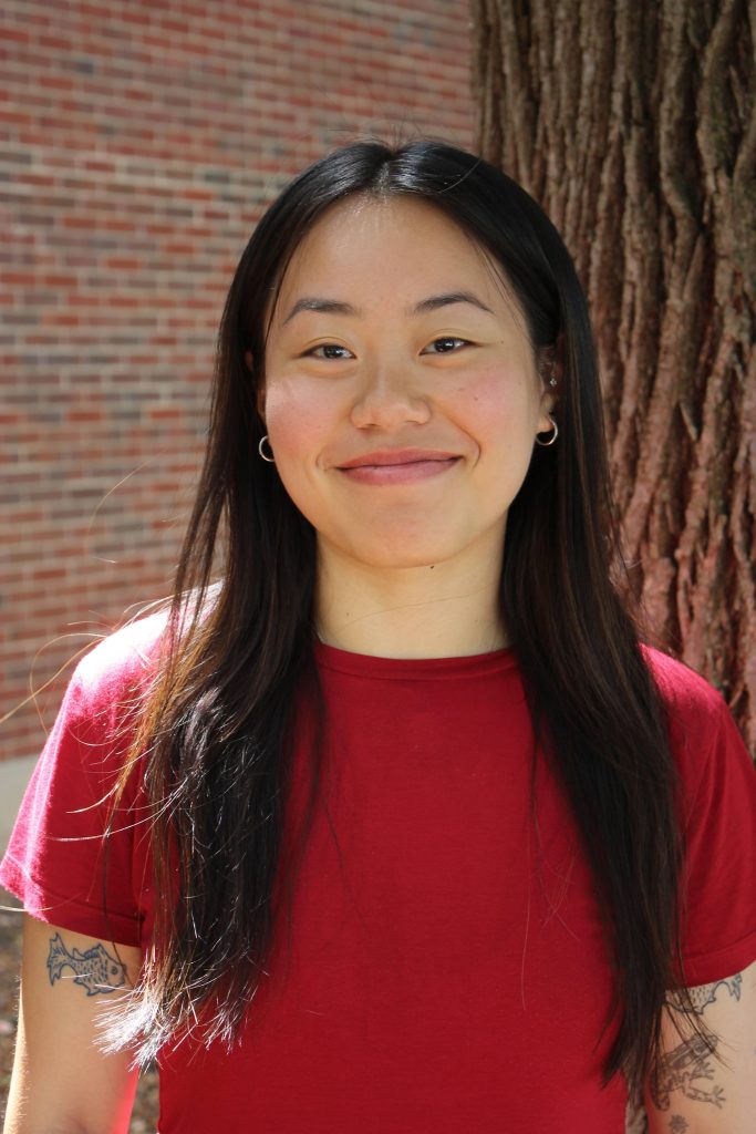 Holly standing in front of tree