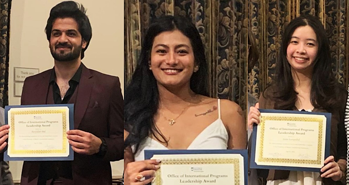 Students posing and holding award certificates
