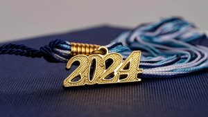 A photo of a mortar board and tassel with 2024 attached