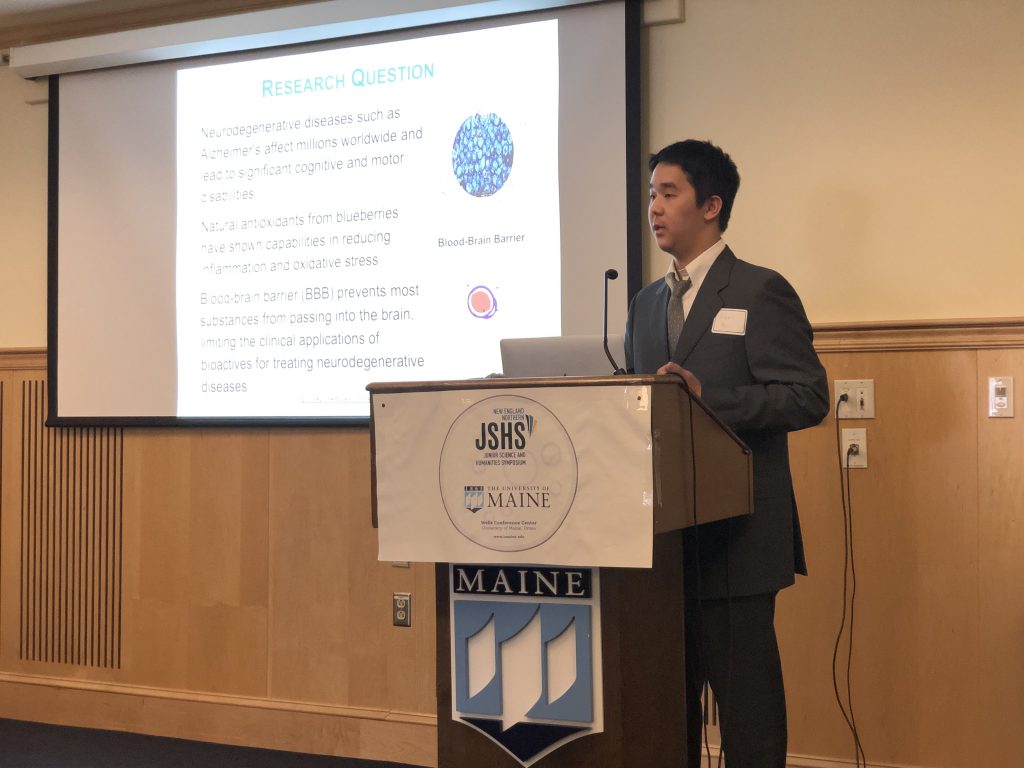 A photo of a student presenting at the podium