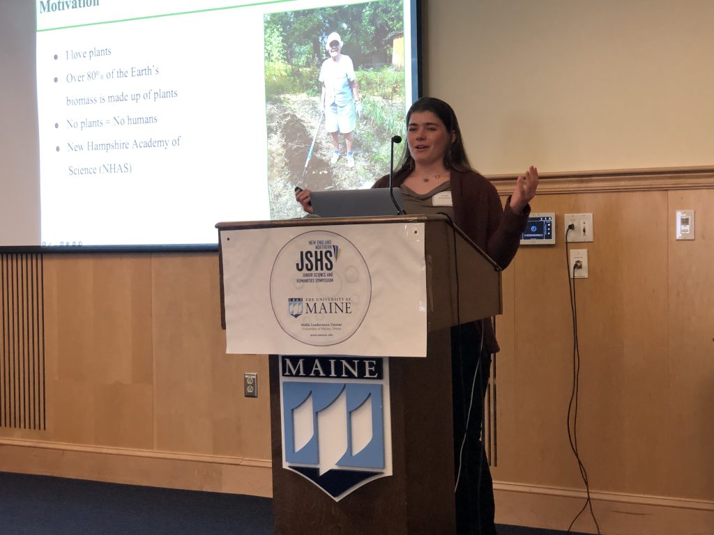 A photo of a student presenting at the podium