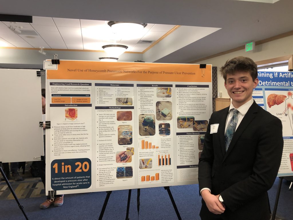 A photo of a student with their poster