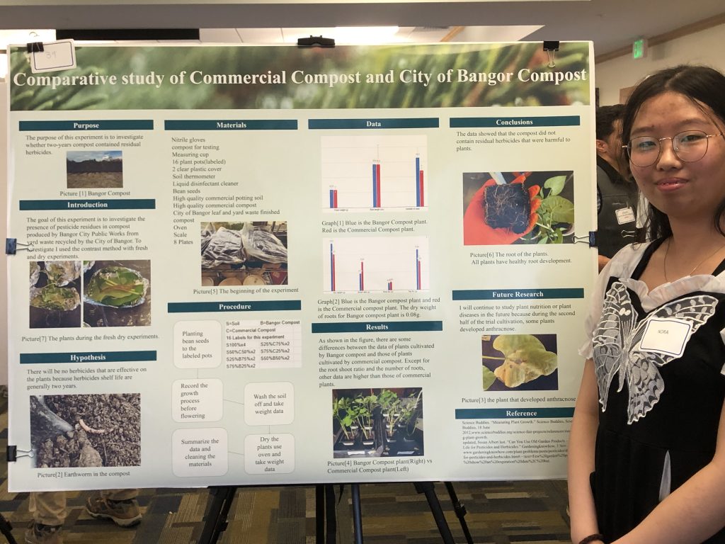 A photo of a student with their poster