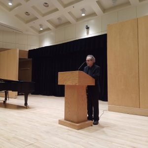 A man, Phillip Silver, speaking at a podium. 