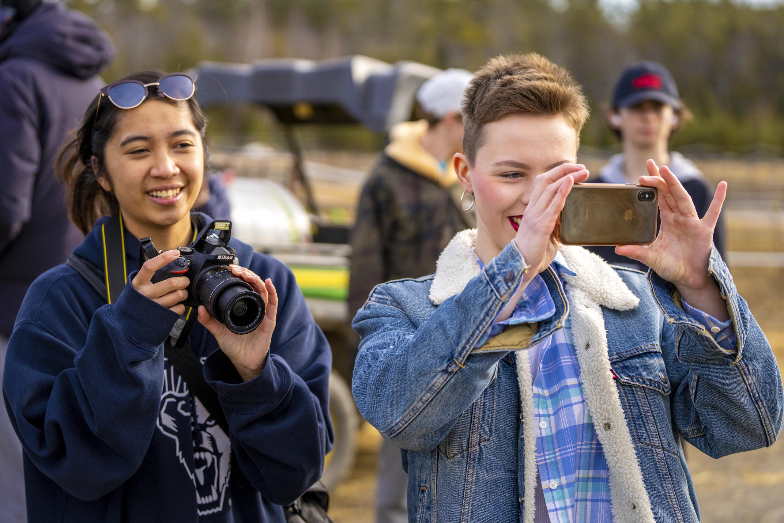 A photo of two students with cameras