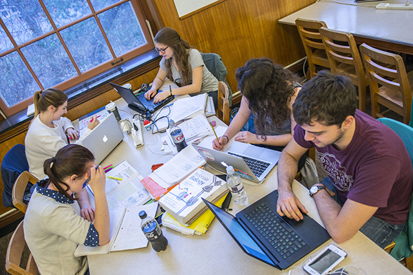 students on laptops in the library