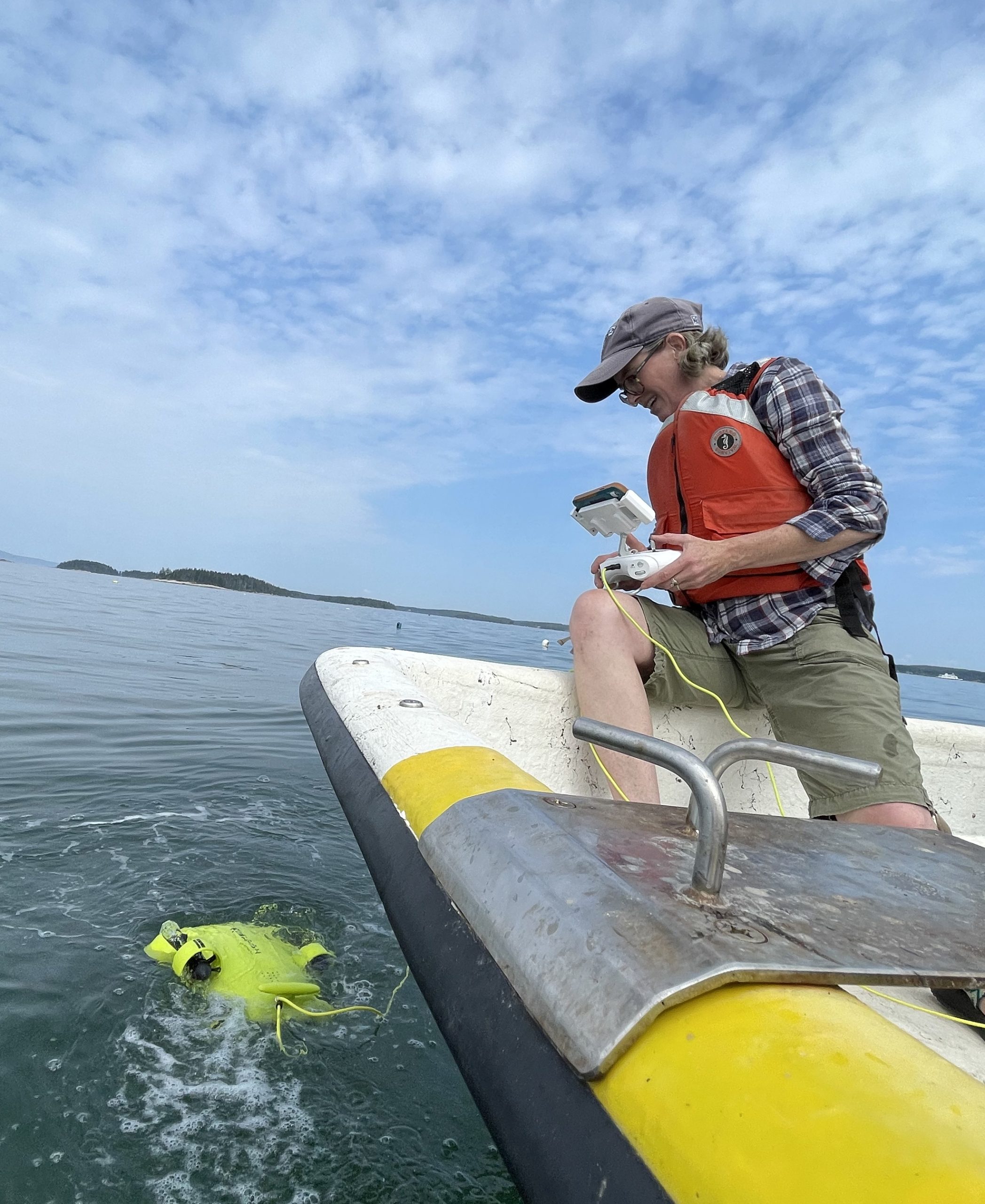 Woman operates drone from boat