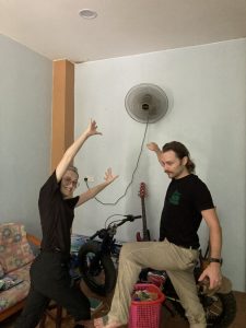 two people dancing in front of a fan