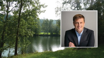 A photo of a lake with a photo of Eric Roy inset within.