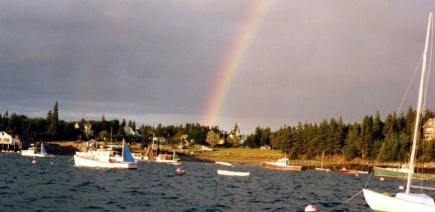 a rainbow over a harbor