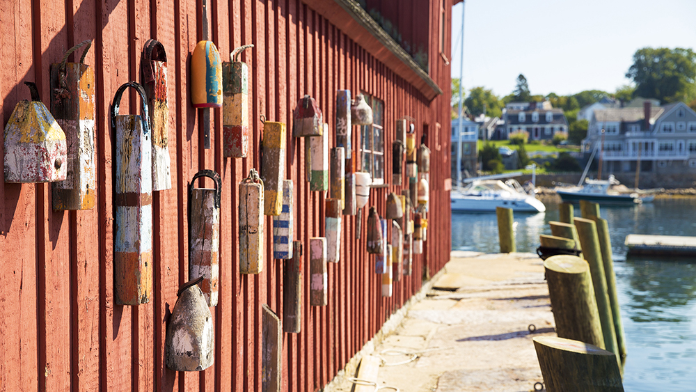 red wooden wall of the house with buoys