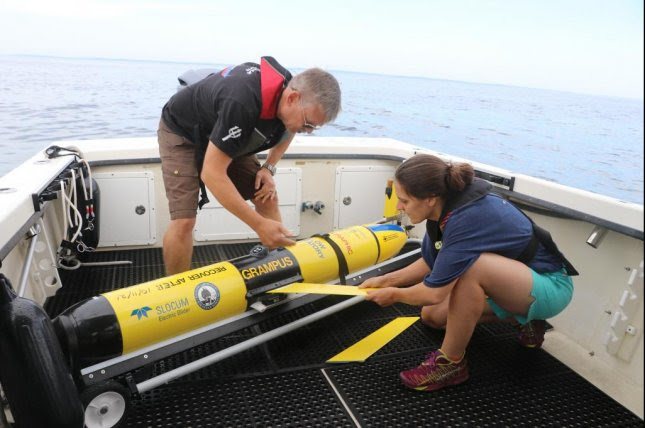 Scientist with rover on boat