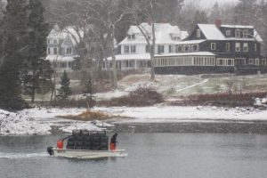 lobster fishing from a skiff in the snow in the river in January