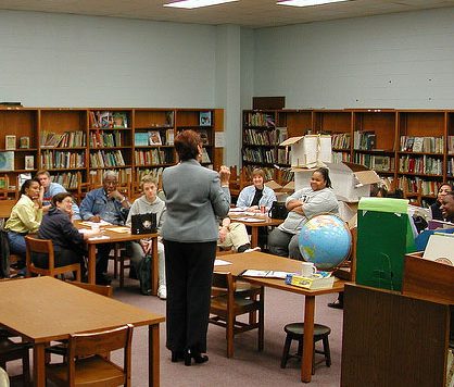 Teachers listening to speaker in library