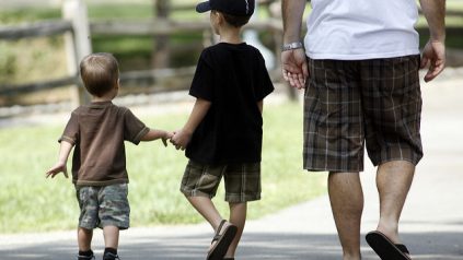 Two young boys walking with Dad