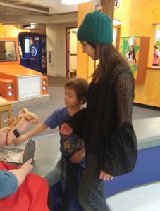 Brother and big sister looking a snake exhibit