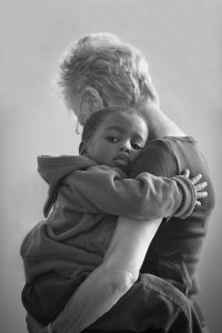 woman holding toddler in arms