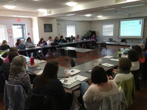 teachers sitting at classroom tables