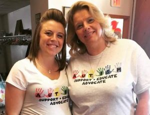 Two women smiling with Autism Awareness t-shirts