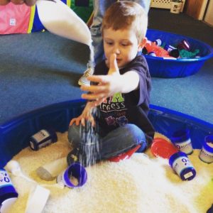 Young boy playing in sandbox