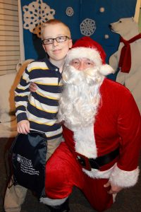 Young boy sitting with Santa