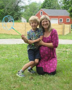 Woman and child together outdoors smiling