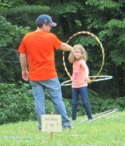 Father and daughter hula hooping