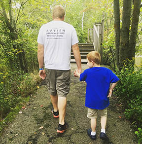 Father and son walking in woods