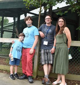 Family posing in front of zoo