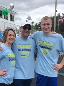 Young adult with parents at track meet