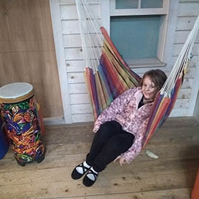 Young girl sitting in hammock