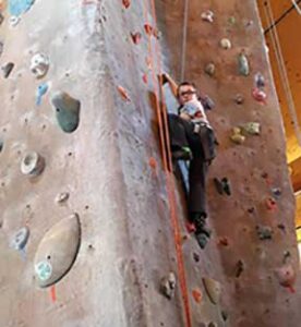 Young boy on climbing wall