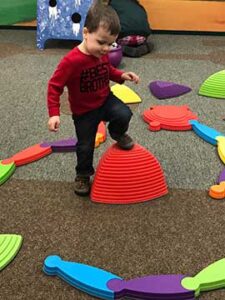 Young boy climbing on toys