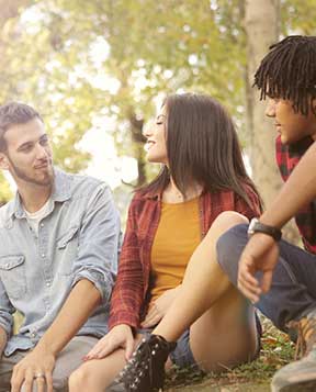 3 young adults chatting