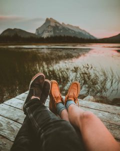 two pairs of legs facing the water