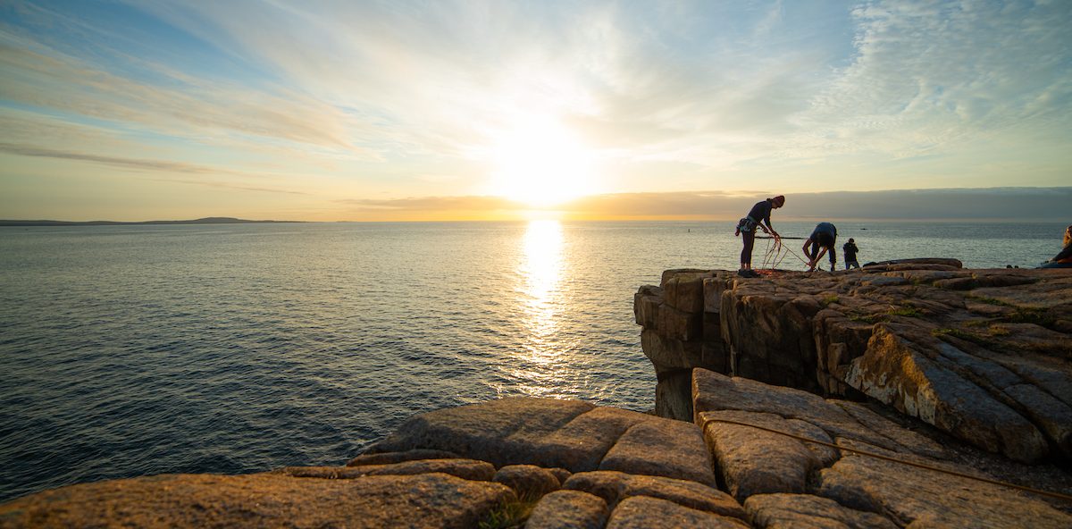 A cliff over the ocean at sunset