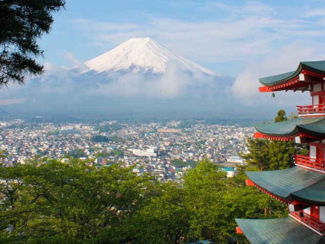 An image of Mount Fuji with the side of a pagoda on the right of the image.