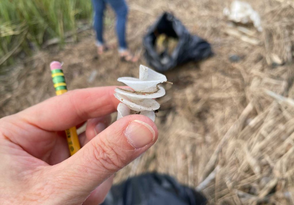 Hand holding a piece of marine debris.