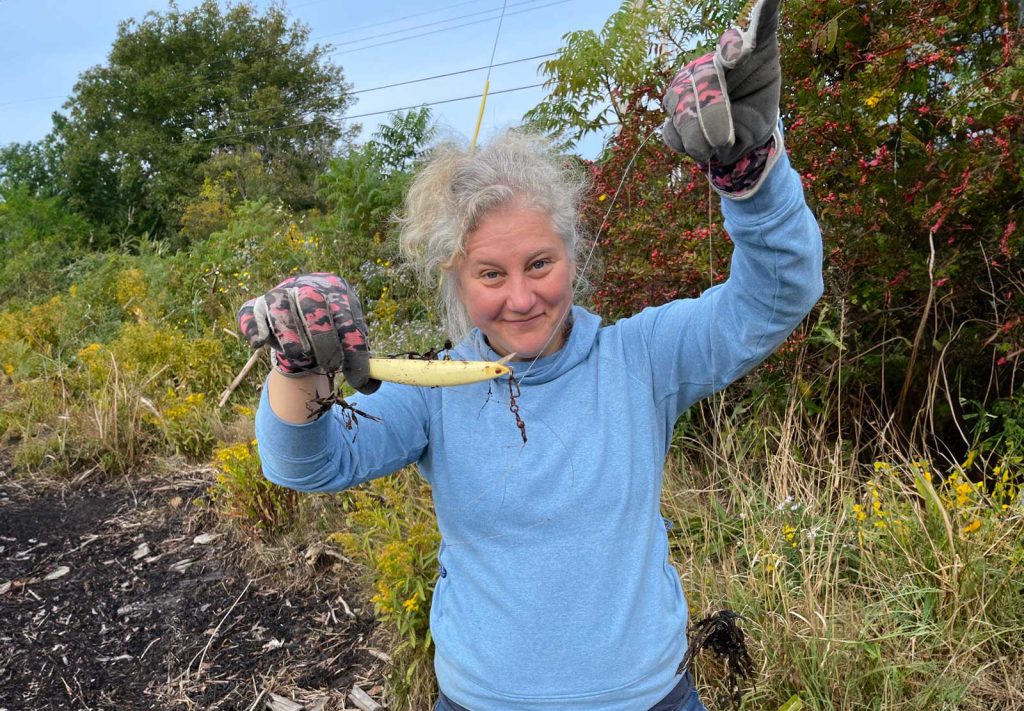 Woman holding fishing line that was disposed of on beach.