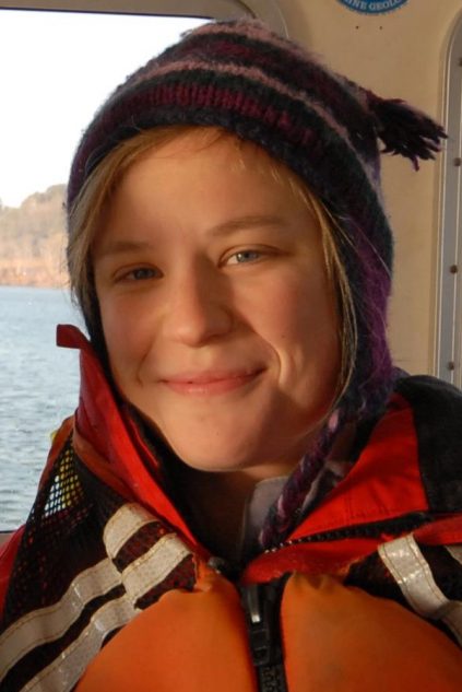 Picture of Skylar Bayer wearing a life jacket on a boat.