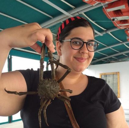 Close up of Emily Nocito holding up a crab.