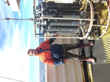 Photo of Constantin Scherelis on the deck of a boat near a machine.