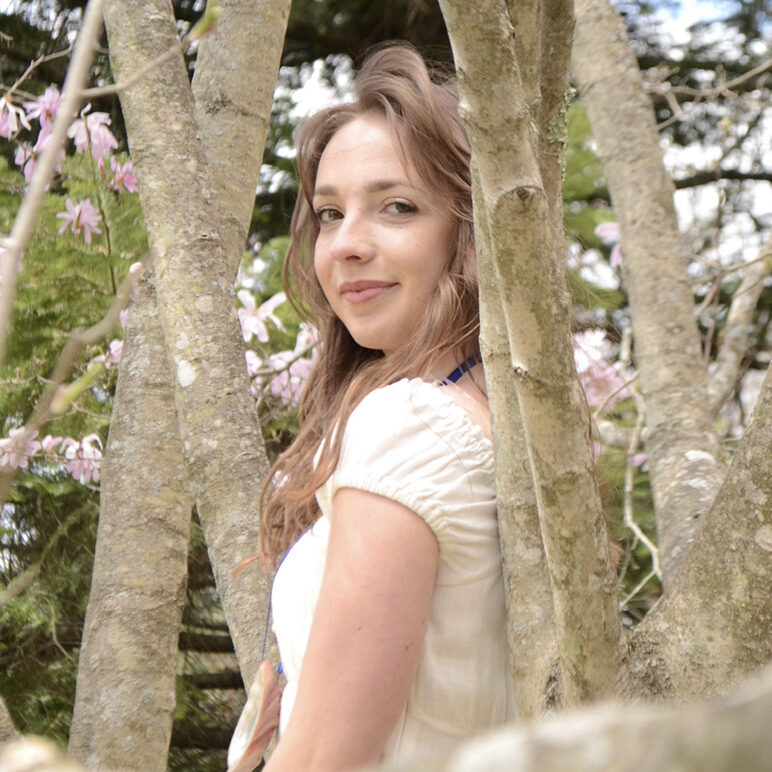 Emma Dullaert standing by trees