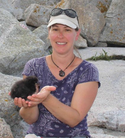 Photo of Michelle Staudinger holding a young puffin