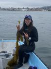 Emma Smith on boat holding seaweed.